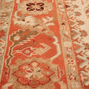 Intricate hand-woven rug featuring traditional motifs in warm tones.