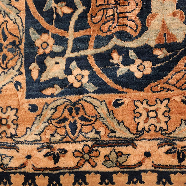 Close-up of intricately patterned, high-quality handcrafted carpet with floral and geometric motifs.