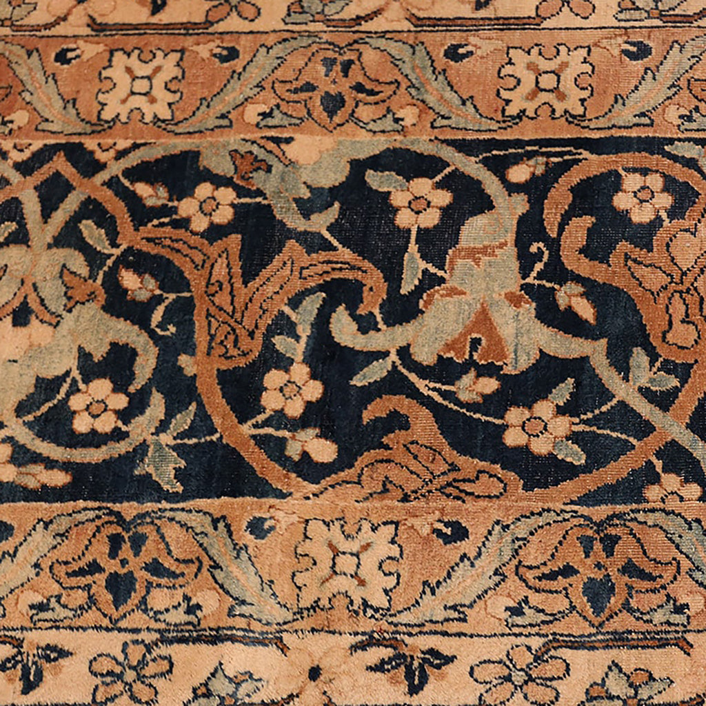 Close-up of a traditional, handcrafted patterned carpet with signs of aging