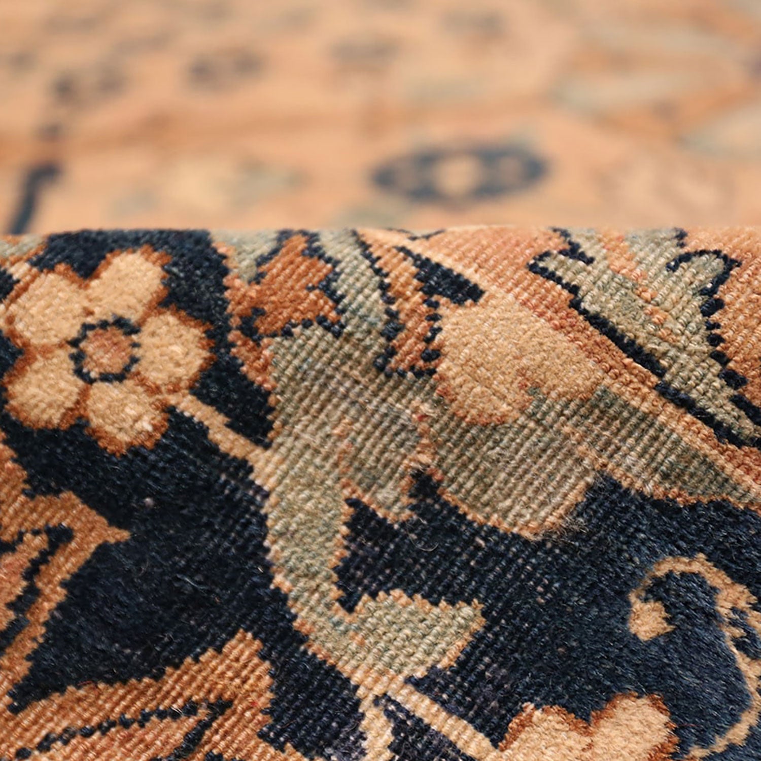 Close-up of a patterned carpet showcasing intricate floral motifs.