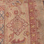 Close-up of a vintage handcrafted carpet with intricate floral patterns.