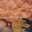 Close-up of rolled up carpet showcasing rich, warm colors and intricate texture.