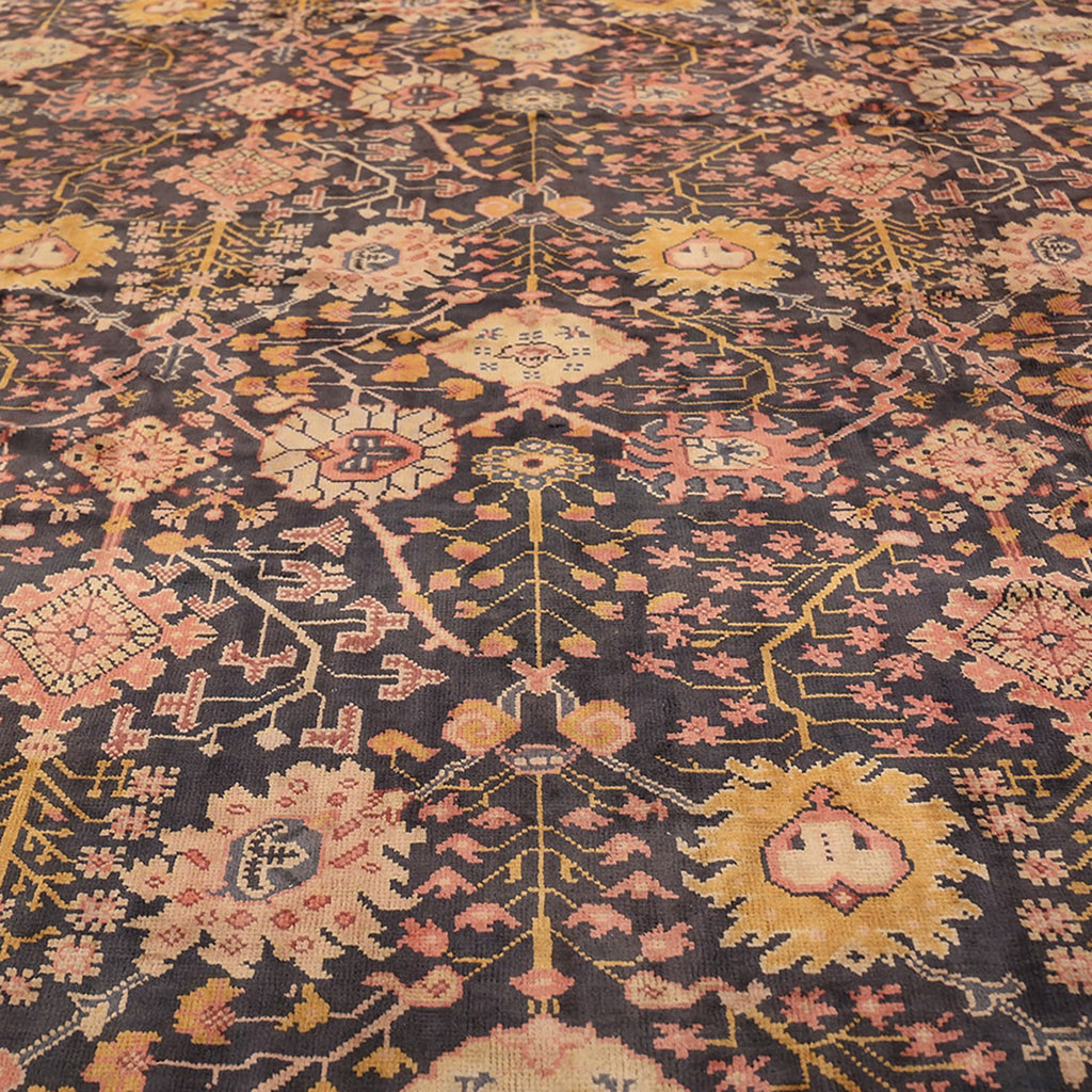 Detail section of an ornate Persian rug with intricate patterns.