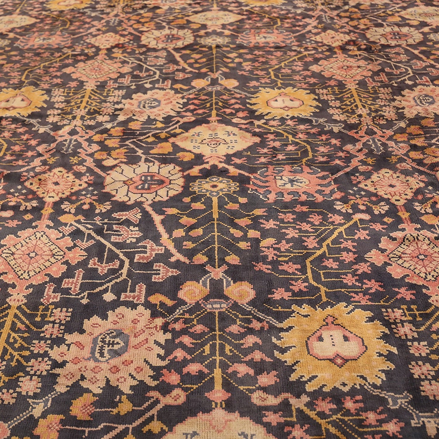 Detail section of an ornate Persian rug with intricate patterns.