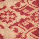 Textured carpet with an ornate floral pattern in contrasting colors.
