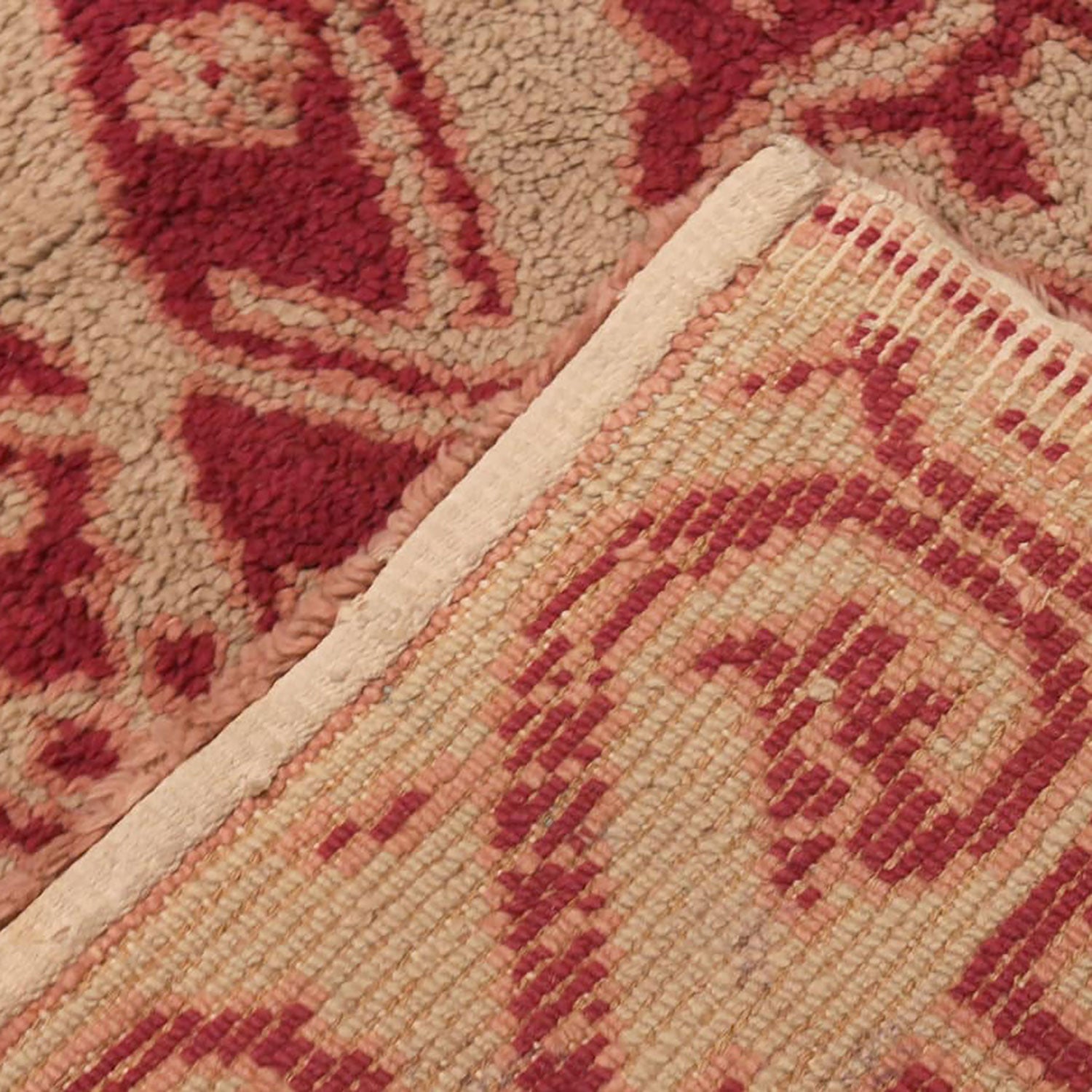 Close-up of two flooring materials: plush carpet meets flatweave mat.