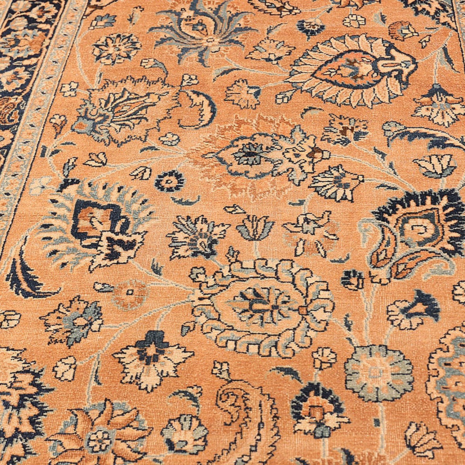 Close-up of a traditional, intricately patterned carpet with warm hues
