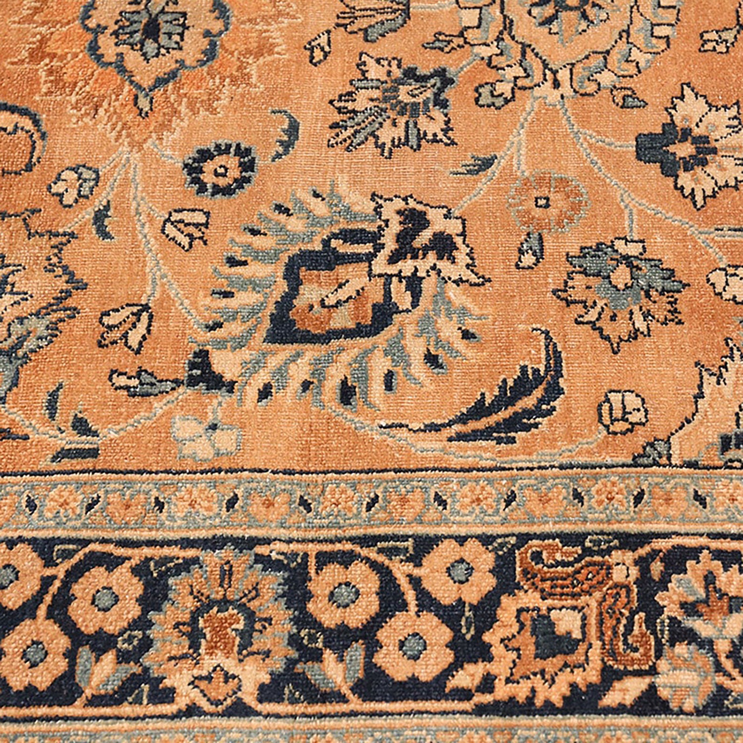 Close-up of a handwoven Oriental rug with intricate floral motifs.
