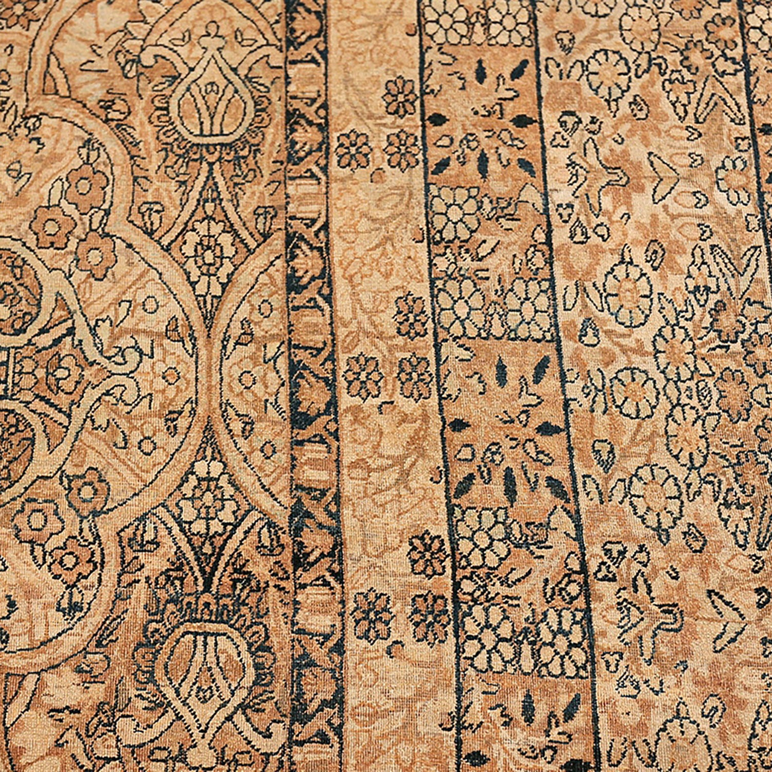 Close-up of an intricate patterned rug in warm earth tones.