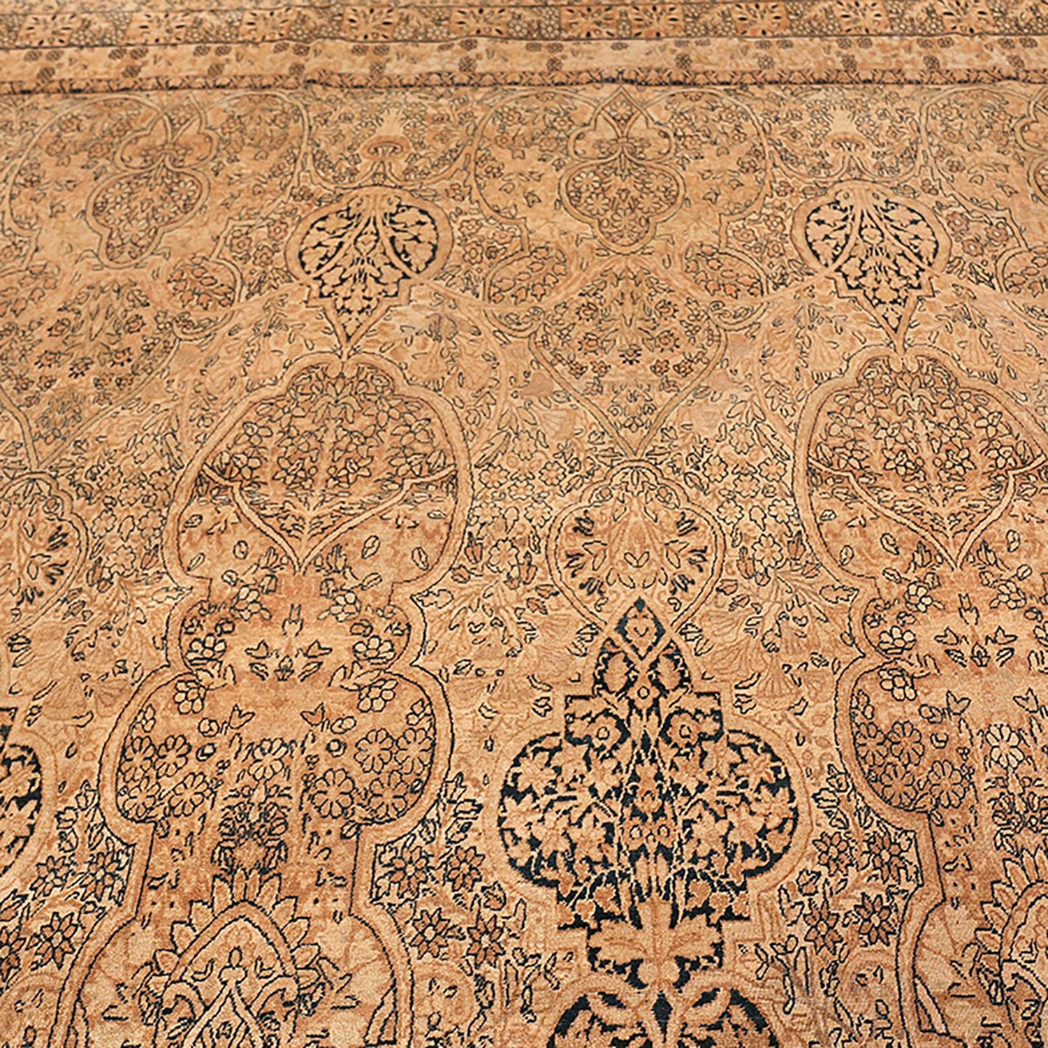 Intricate floral and botanical motif in earthy tones on carpet.