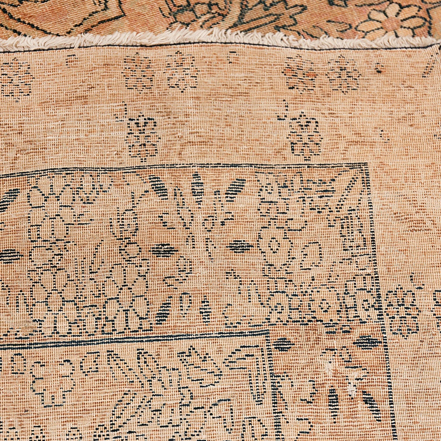 Close-up of a high-quality woven rug with floral and geometric patterns.