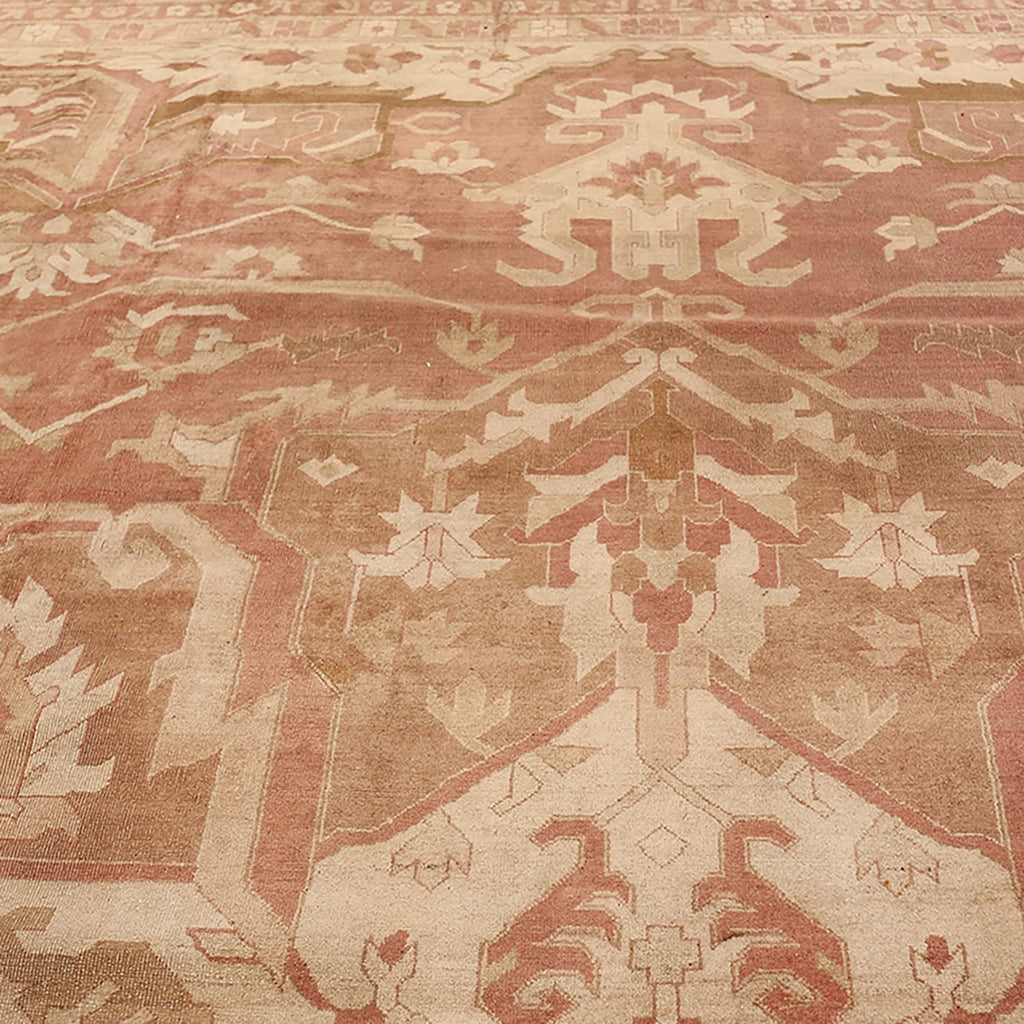 Intricate, symmetrical design of a gently worn Middle Eastern-inspired carpet.