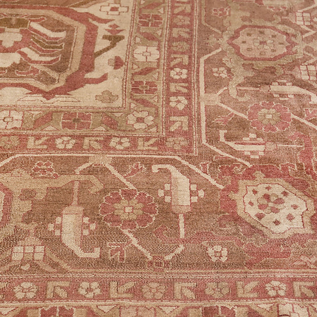 Intricate, antique rug showcases traditional Persian design in red and beige.