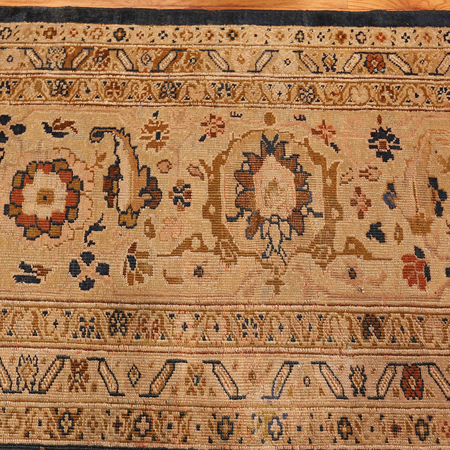 Intricate traditional rug displays detailed patterns and motifs in rich colors.