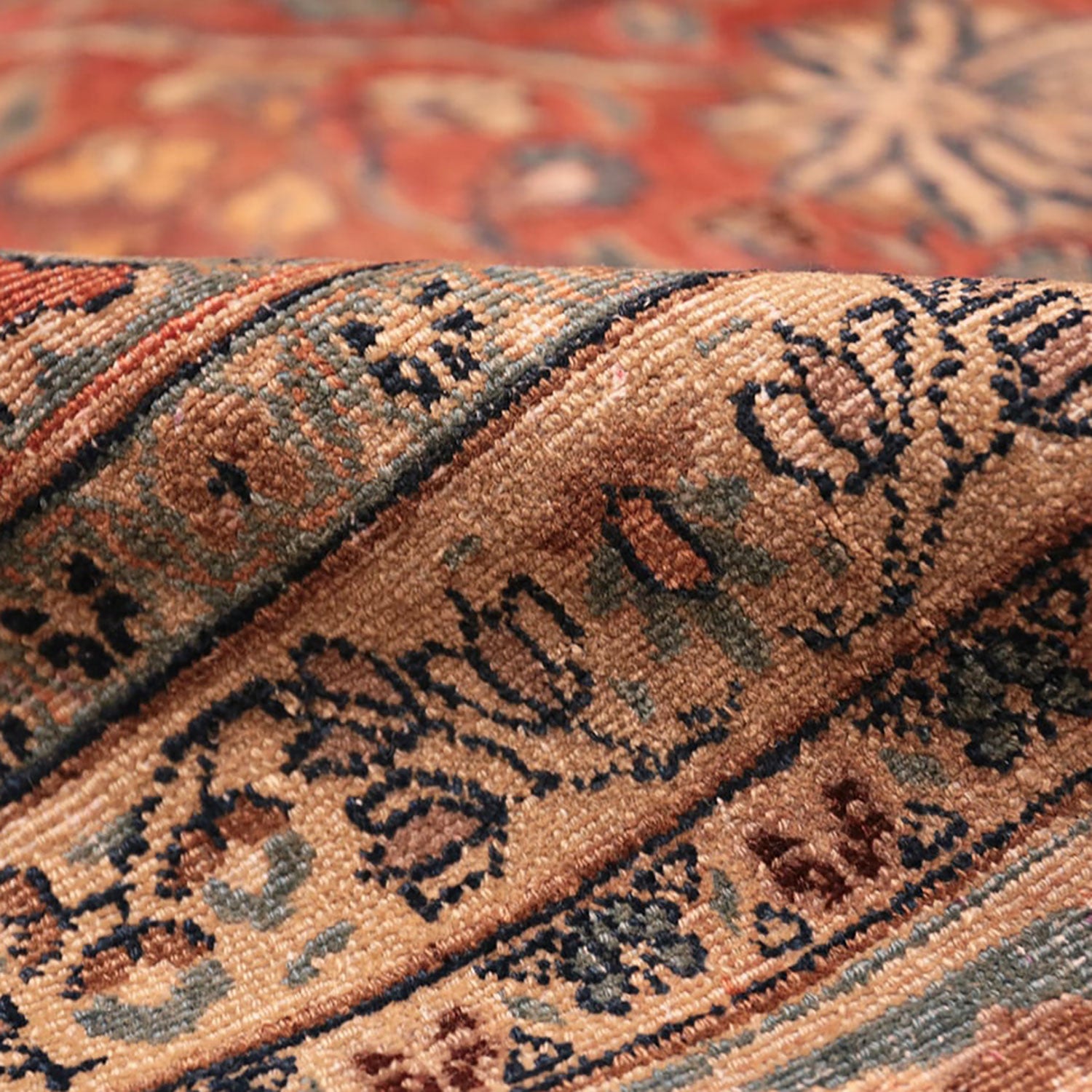 Close-up of a folded, patterned rug showcasing intricate details.