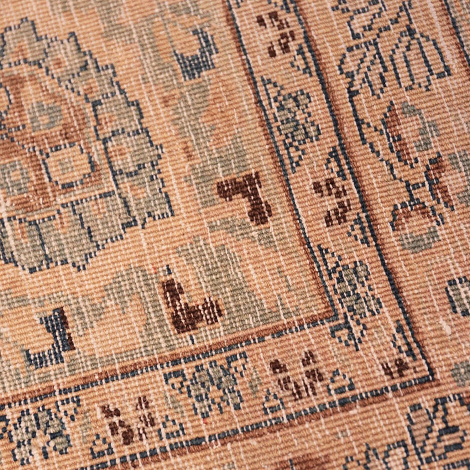 Intricate handcrafted woven fabric with geometric motifs in earth tones.