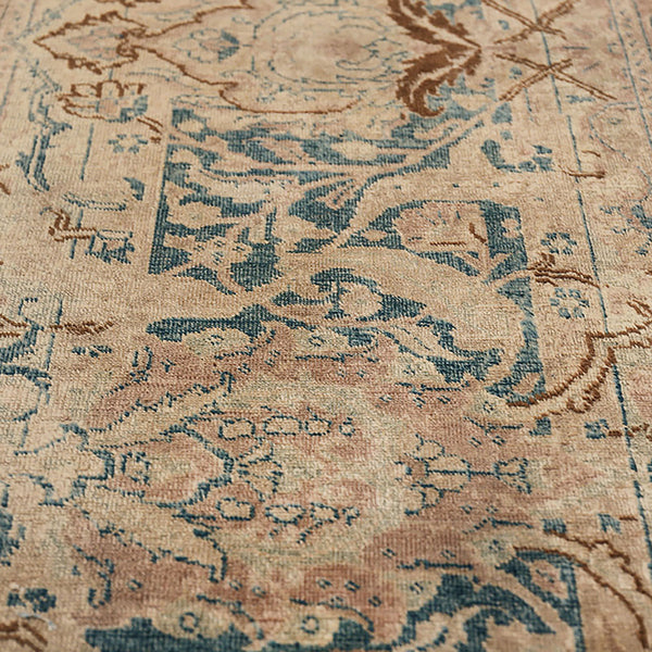 Close-up of an intricately designed, aged ornate rug or carpet.