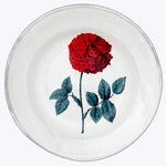 Handcrafted ceramic plate with red rose illustration on white background.