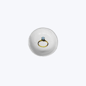 Elegant diamond ring on gold band symbolizes commitment and love.