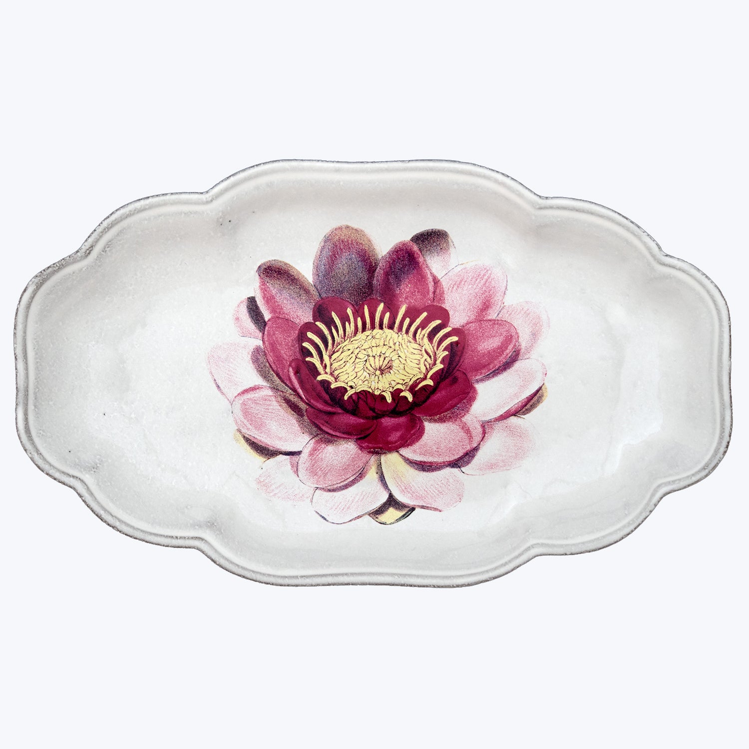 Delicate ceramic dish with pink flower design and scalloped edge.