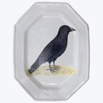 Octagonal glass plate with detailed crow illustration on rim.