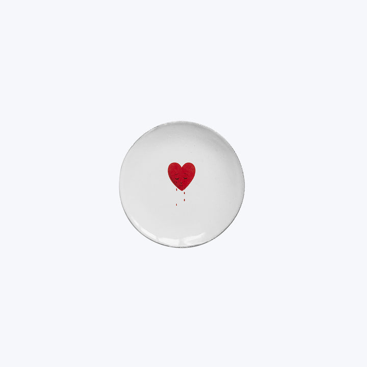 Hand-painted red heart on white ceramic plate, minimalist romantic design.