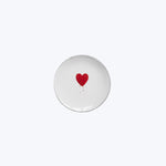 Hand-painted red heart on white ceramic plate, minimalist romantic design.