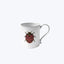 Vintage white mug with red ladybug illustration and curved handle.