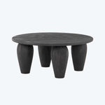 Modern round table with unique design, dark matte finish.
