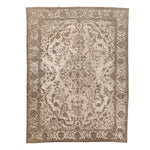 Ornate rectangular rug with floral and paisley motifs in beige