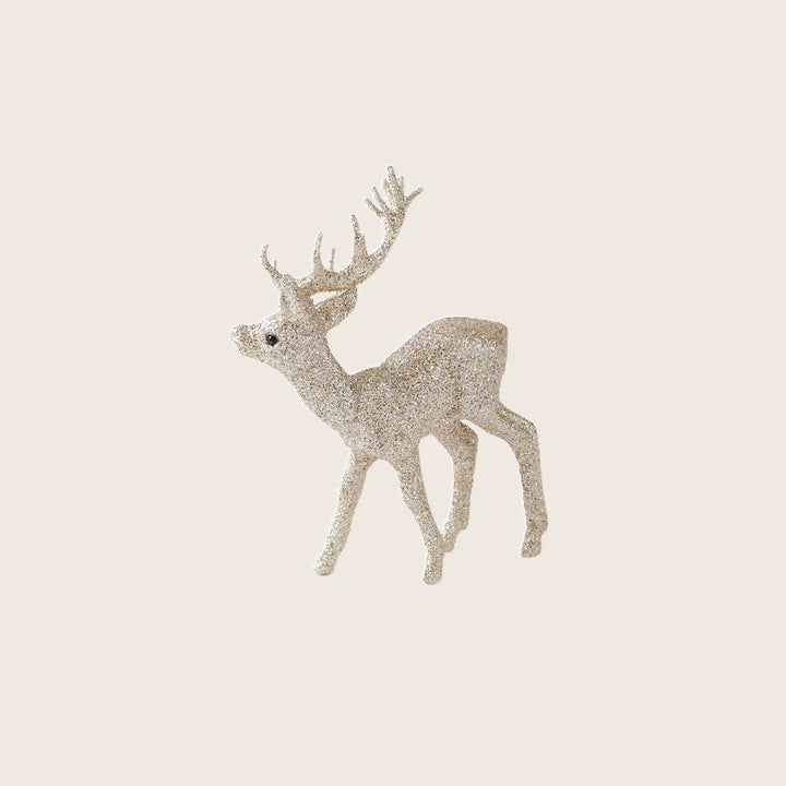 Glittery deer figurine with antlers on white background, holiday decoration.