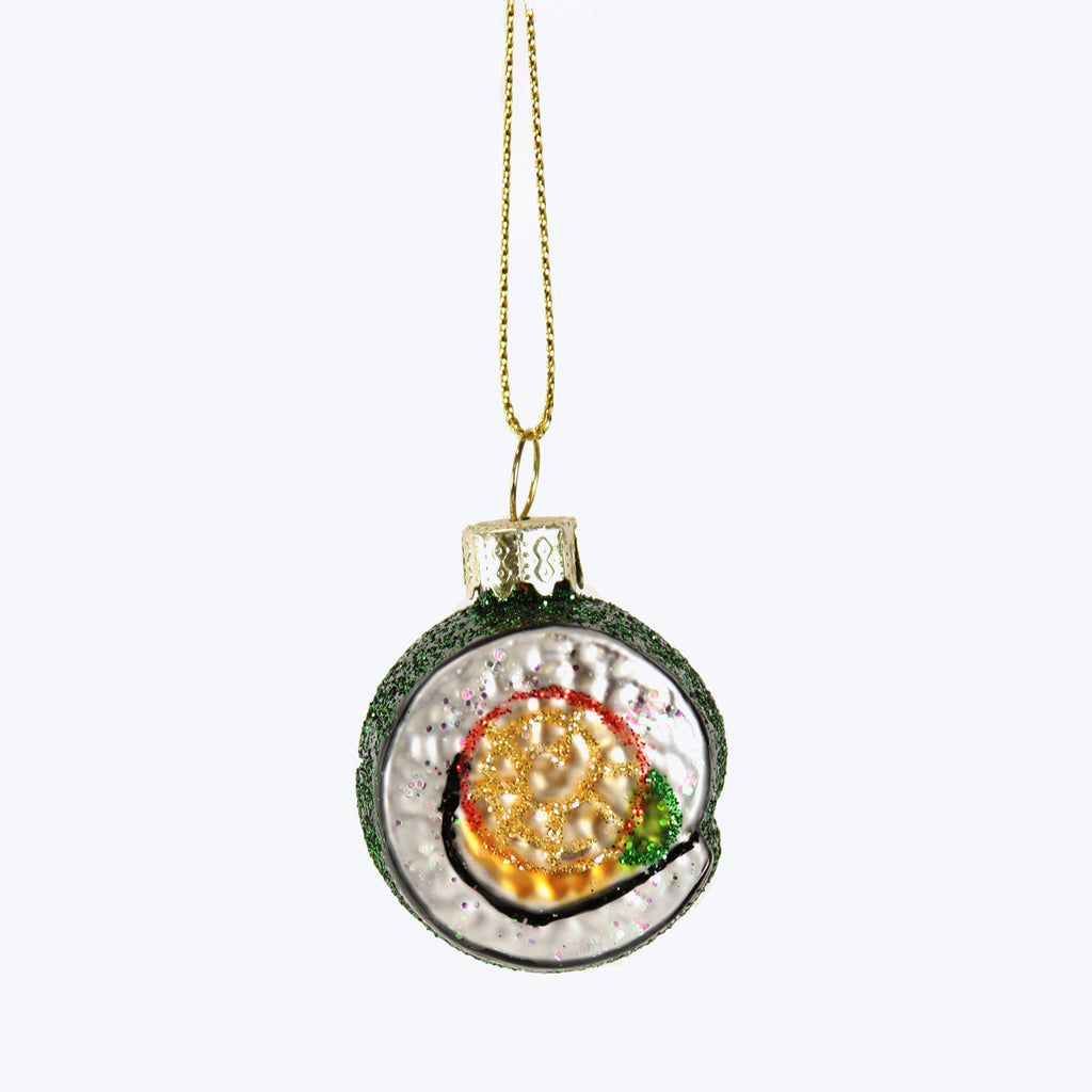 Whimsical kiwi fruit ornament with glitter for Christmas decor.