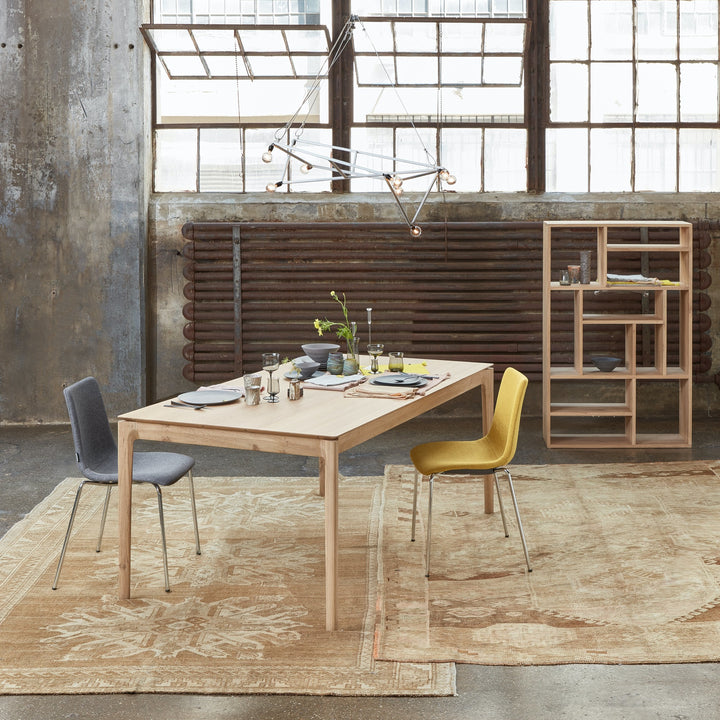 Industrial-style dining area with modern furniture and vibrant color accents.