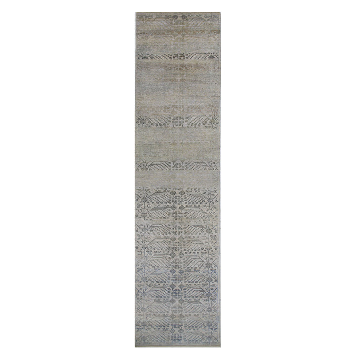 Vintage runner rug with geometric and abstract motifs in muted tones.