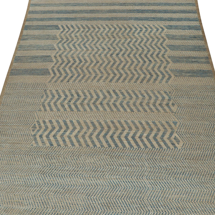 Close-up view of blue and neutral striped chevron area rug.