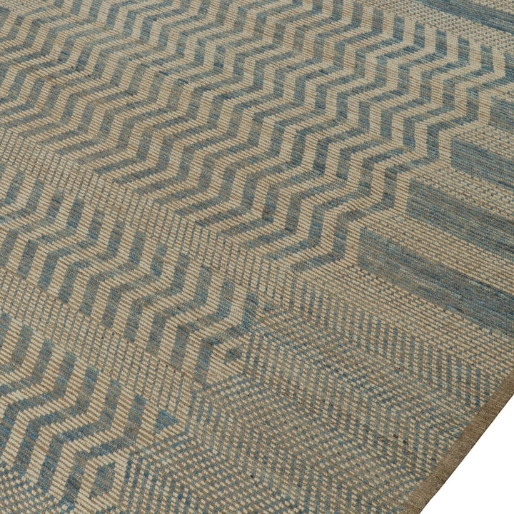 Close-up of textured fabric with geometric blue and beige pattern.