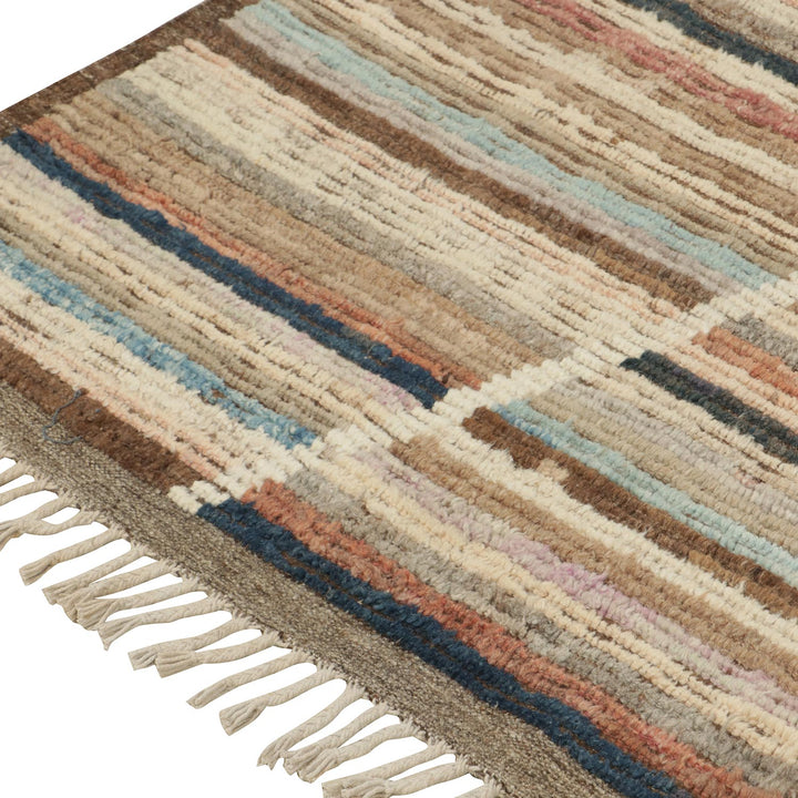 Colorful woven rug with plush texture and fringed edges close-up.