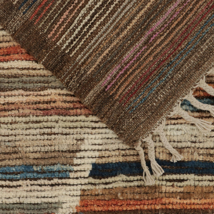 Close-up of handwoven textiles with intricate stripes, colorful fibers, fringe.