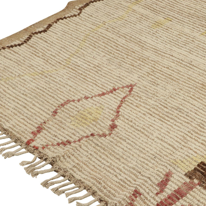 Close-up of beige woven rug with geometric patterns in colors.