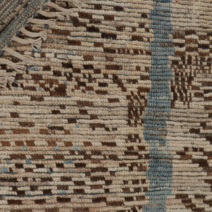 Close-up of handwoven textile with brown, beige, and blue pattern