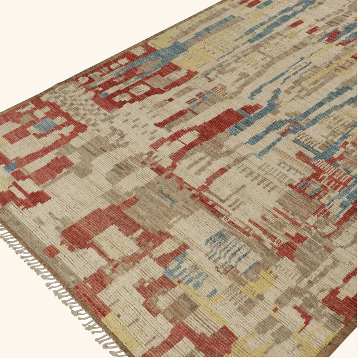 Colorful, abstract patterned hand-woven rug with fringe detail.