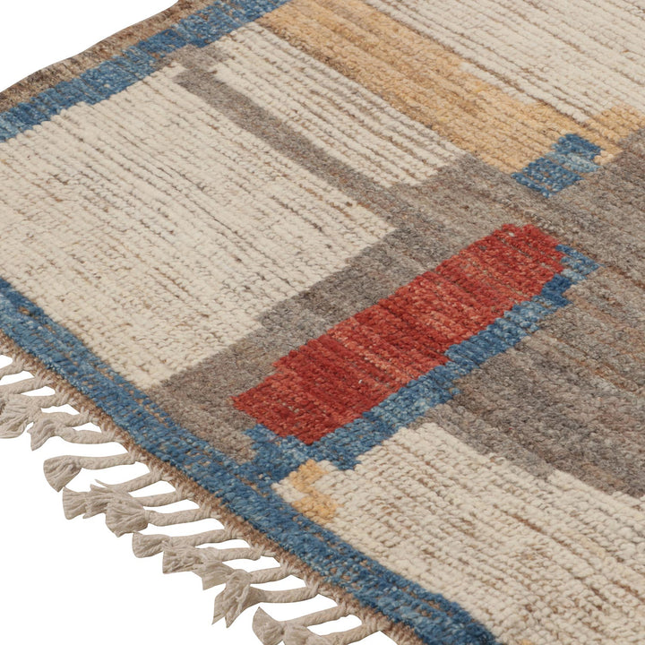 Close-up of colorful geometric patterned rug with fringe detail.