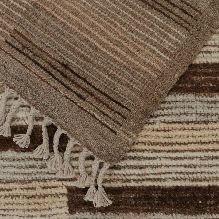 Close-up of handwoven textile with striped pattern in earth tones