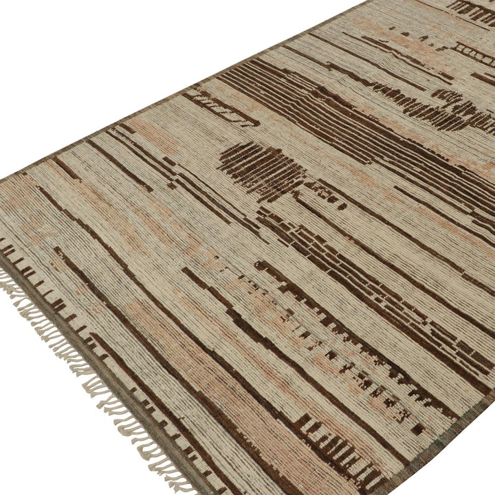 Handwoven beige and brown rug with intricate linear patterns and fringes