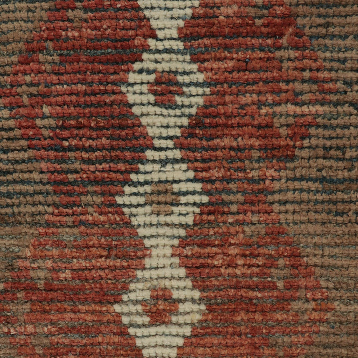 Close-up of textured woven fabric with geometric shapes and colors.