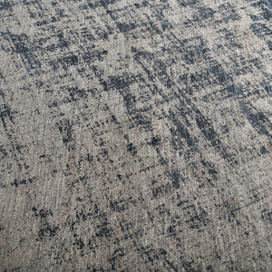Rectangular distressed area rug with abstract blue and beige pattern. - hover