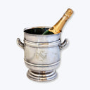 Elegant silver ice bucket with champagne bottle and monogram initials.