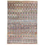 Intricate geometric patterned area rug with rich colors and detail.