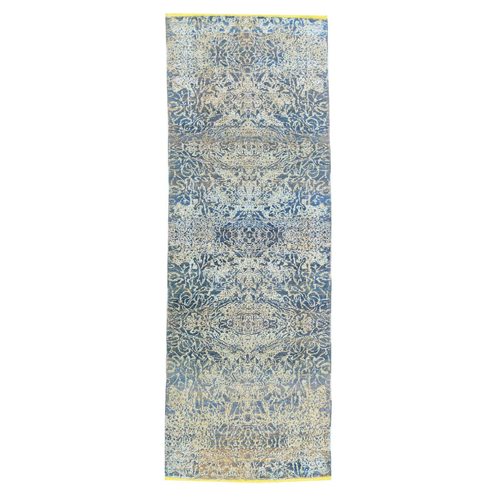 Intricate blue and white textile with symmetrical ornate patterns.