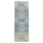 Intricate blue and white textile with symmetrical ornate patterns.